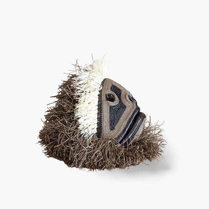 Side profile view of dimensional handwoven palm leaf monkey mask showing sculptural depth
