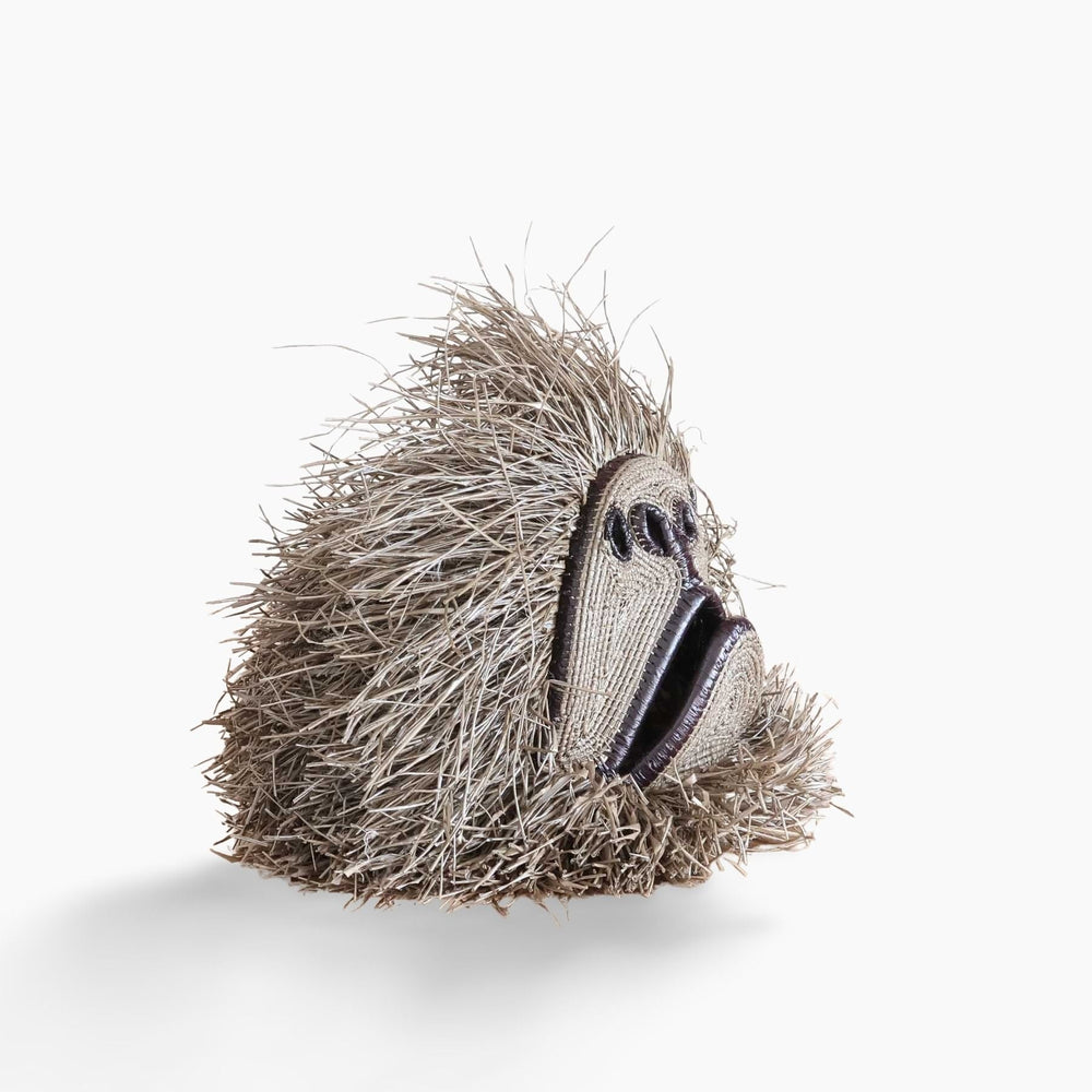 Side view showing dimensional woven form and layered palm fiber fringe detail