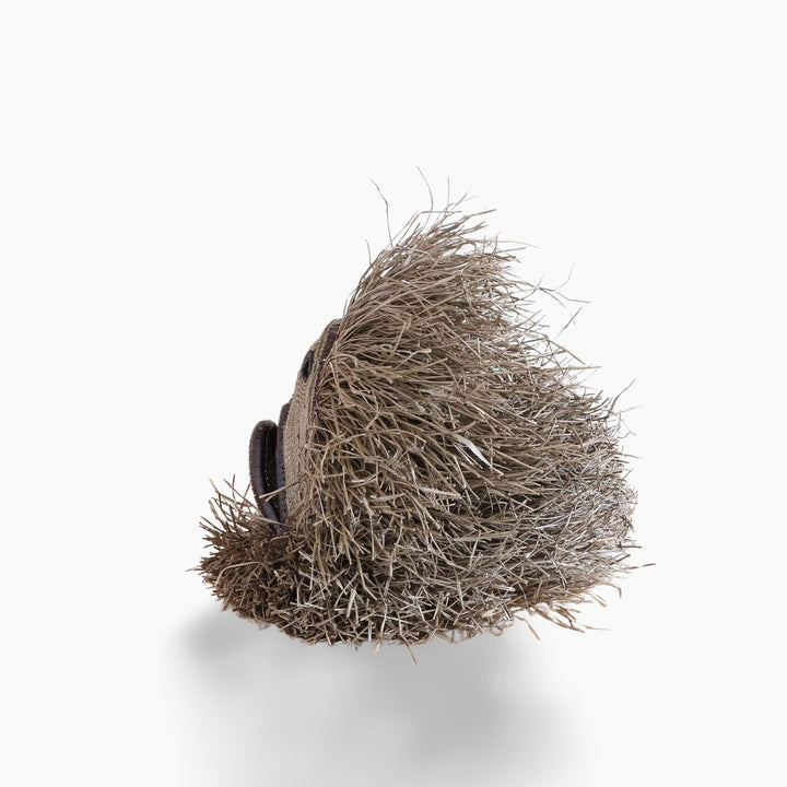 Side view showing dimensional woven form and layered palm fiber fringe detail