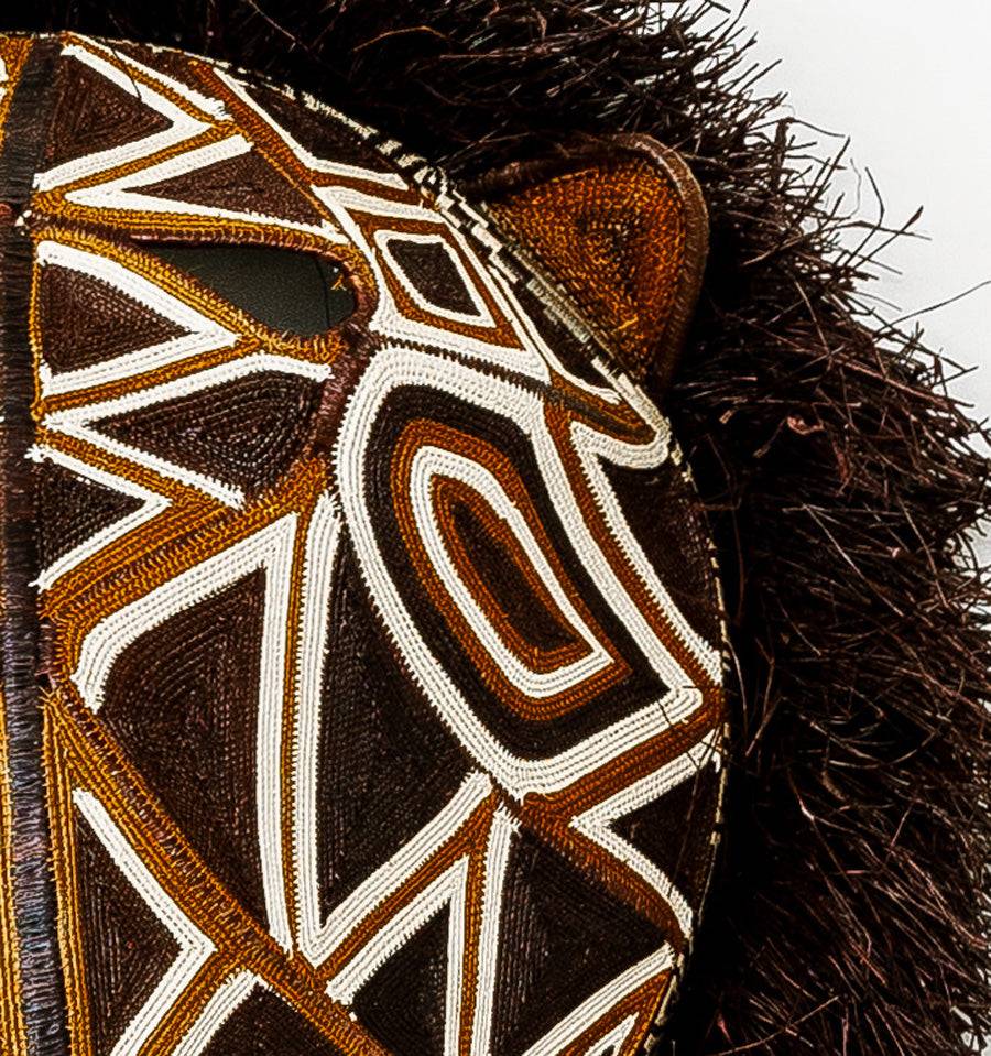 Close-up detail of intricate palm fiber weaving and geometric patterns on Embera cat mask