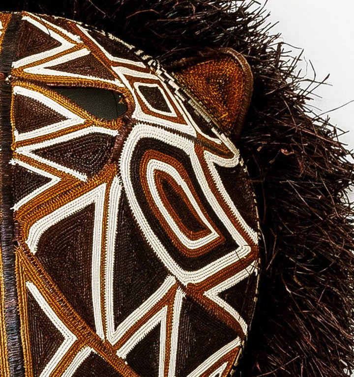 Close-up detail of intricate palm fiber weaving and geometric patterns on Embera cat mask