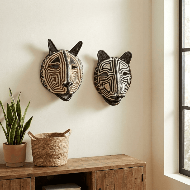 handwoven masks displayed on plain wall in a modern tribal interior