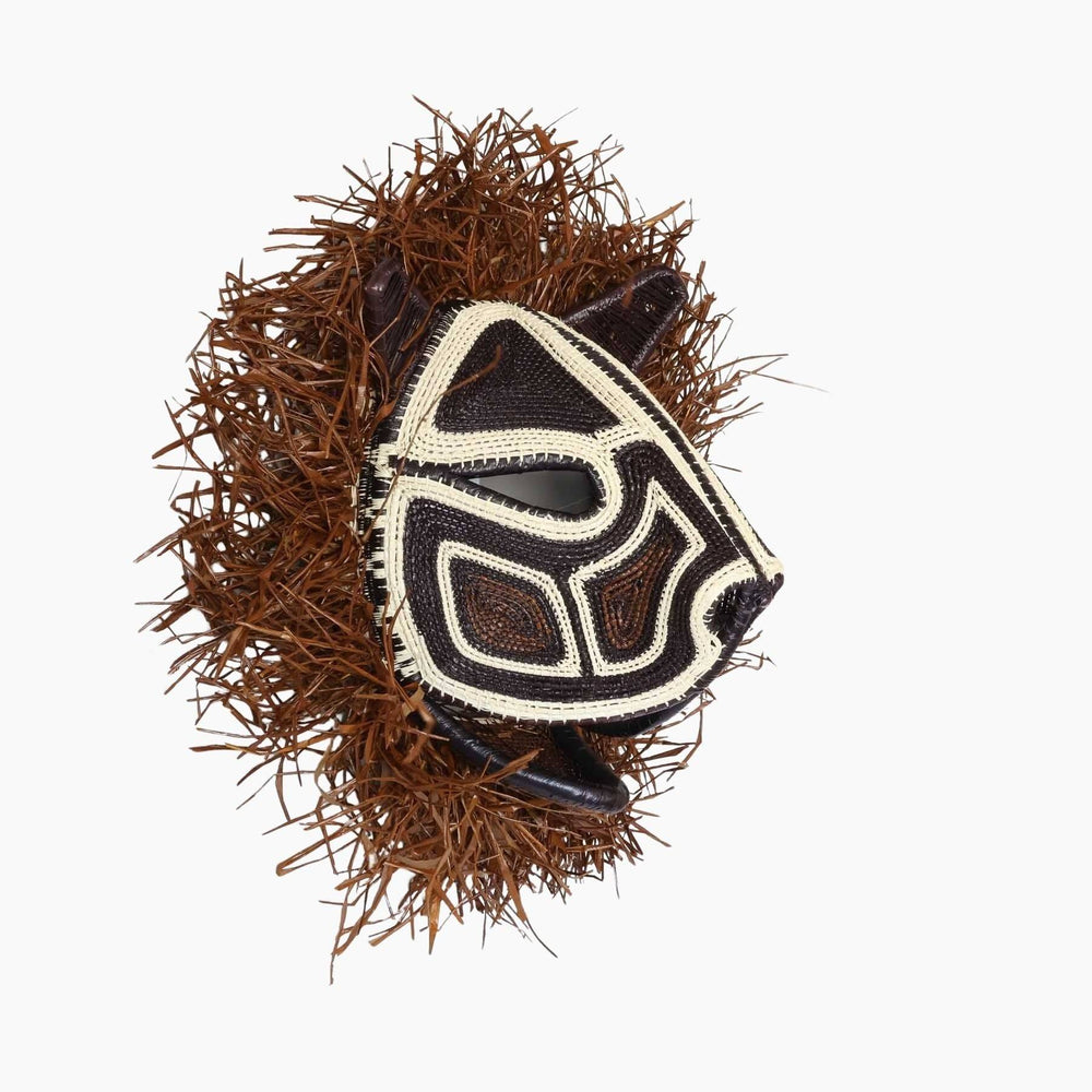 Side view showing sculptural form and woven fringe detail of Emberá mask