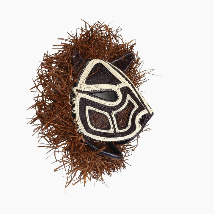Side view showing sculptural form and woven fringe detail of Emberá mask