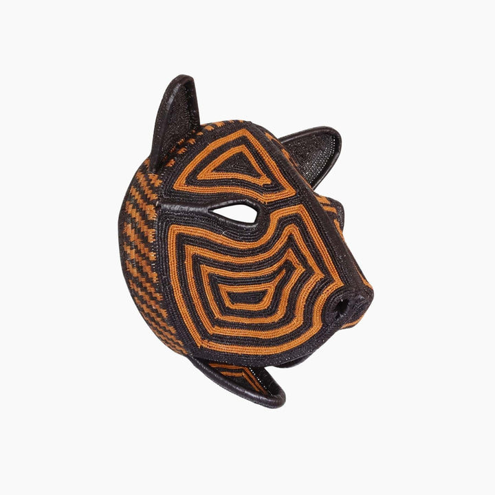 Side view of sculptural palm leaf cat mask showing three-dimensional weaving technique