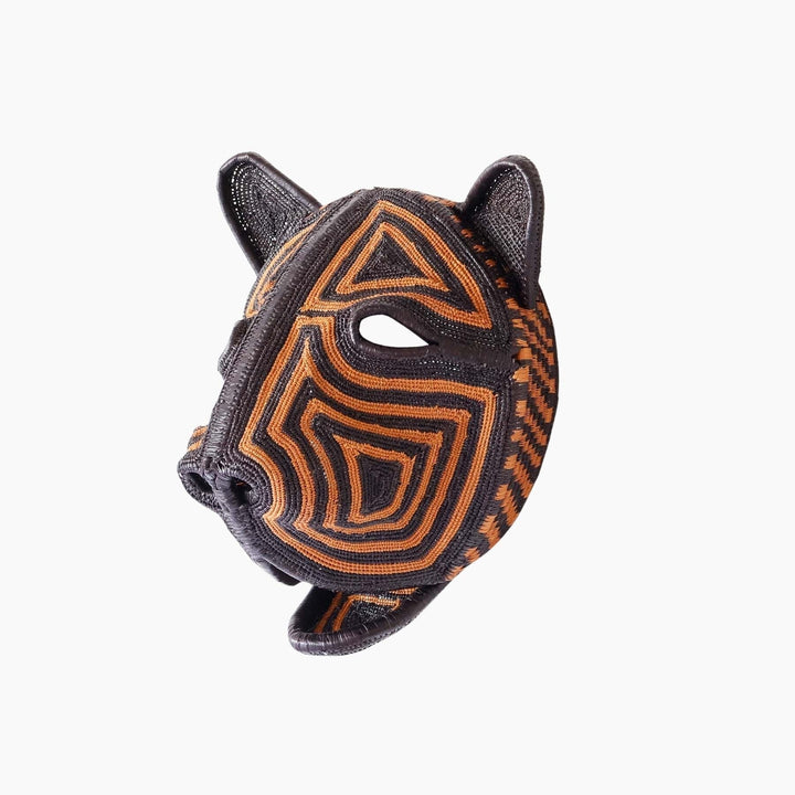 Side view of sculptural palm leaf cat mask showing three-dimensional weaving technique