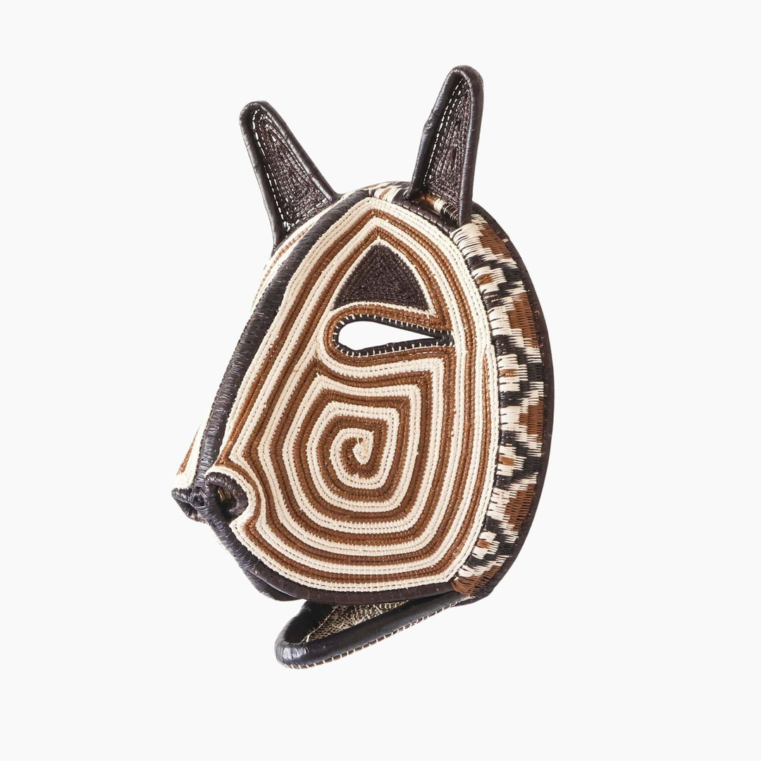 Side profile of handmade Embera ceremonial cat mask showing dimensional palm leaf construction