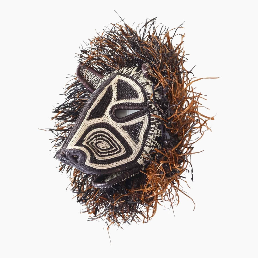 Side profile view of handwoven Panama rainforest cat mask showing dimensional weaving