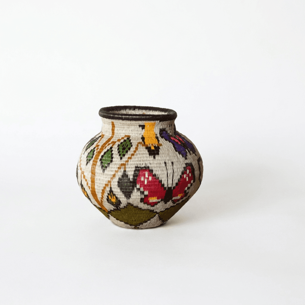 Handwoven Wounaan basket with crimson butterfly, golden blooms and green vines on cream palm fiber