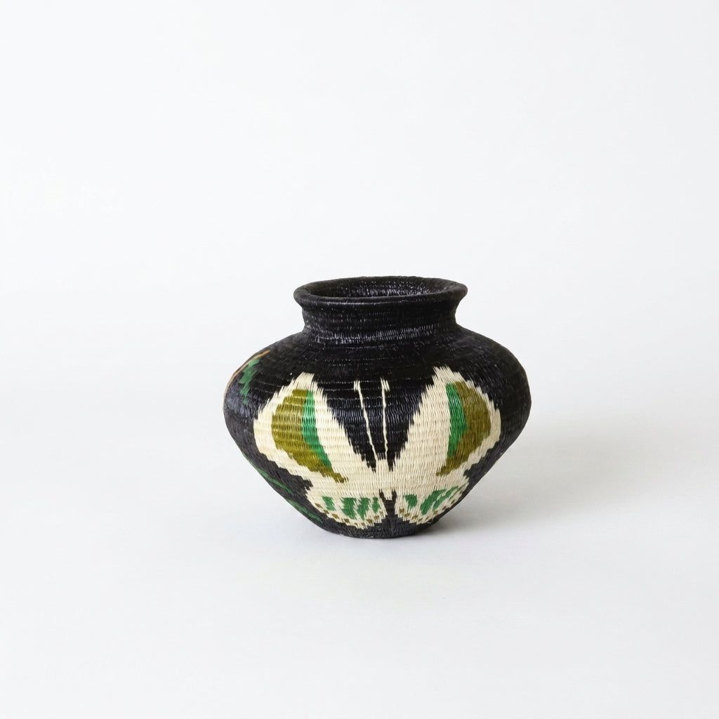 Black handwoven Wounaan basket from Panama with large ivory butterfly veined in olive and emerald green
