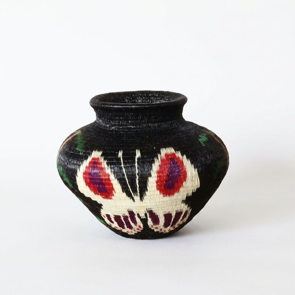 Handwoven Wounaan basket, ivory butterfly with crimson and violet eyespots on jet-black coiled weave