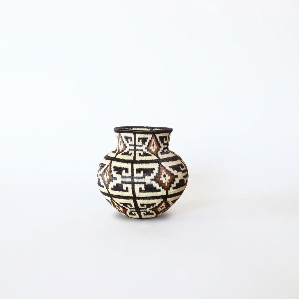 Small geometric handwoven Wounaan basket with stepped maze pattern in brown, ivory and cinnamon