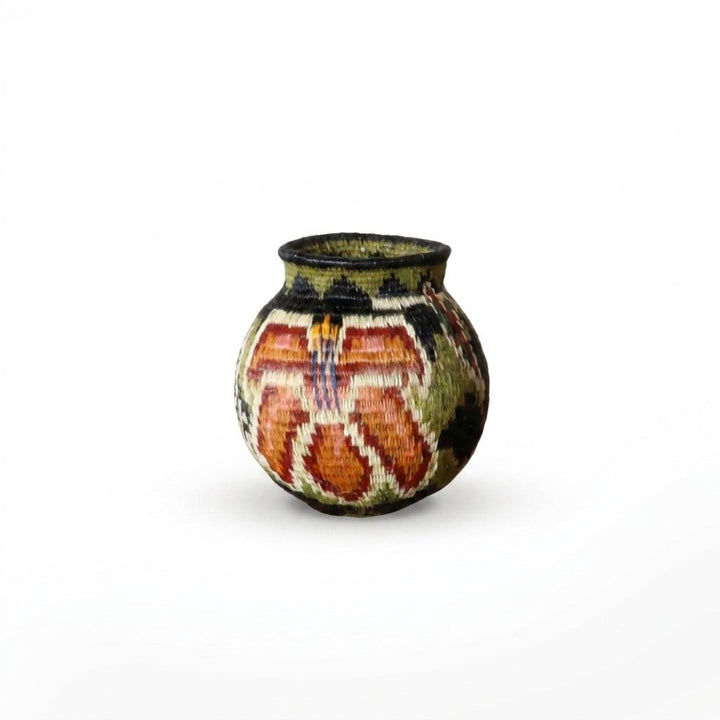 Tiny handwoven Wounaan basket with soft wildflower tapestry in terracotta, salmon and olive on cream, Panama