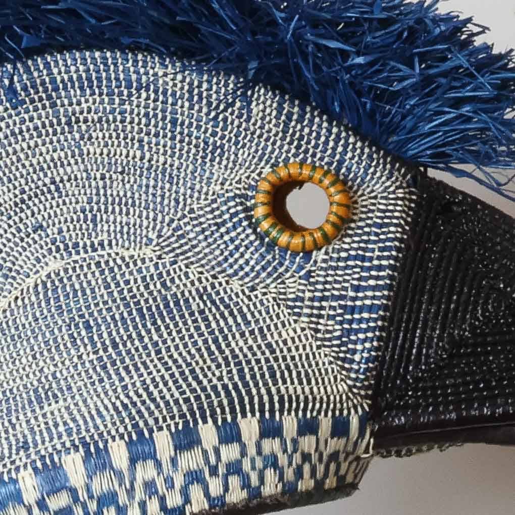 Close-up detail showing intricate hand-painted feathers on Embera hummingbird ceremonial mask