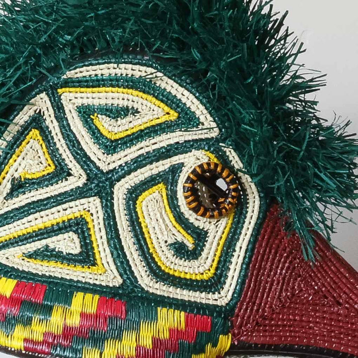 Close-up of handwoven triangle geometric patterns on ceremonial hummingbird mask