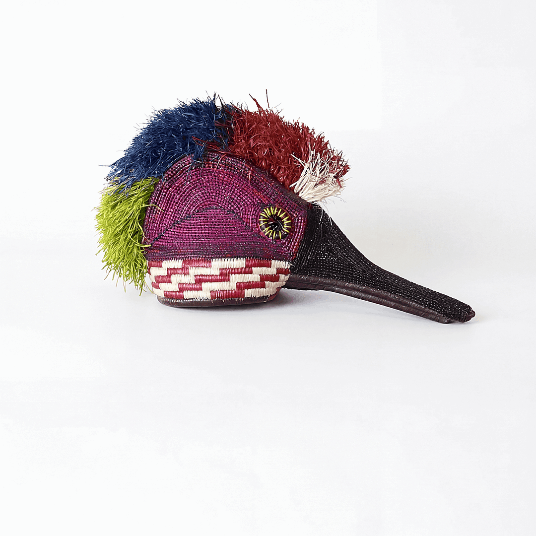 Handmade ceremonial hummingbird mask with crimson collar details by Embera artisans from Panama rainforest