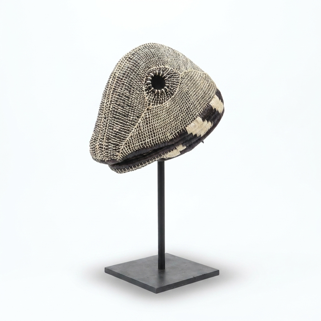 Handwoven Emberá lizard mask in mottled black, grey and ivory palm fiber, from Panama