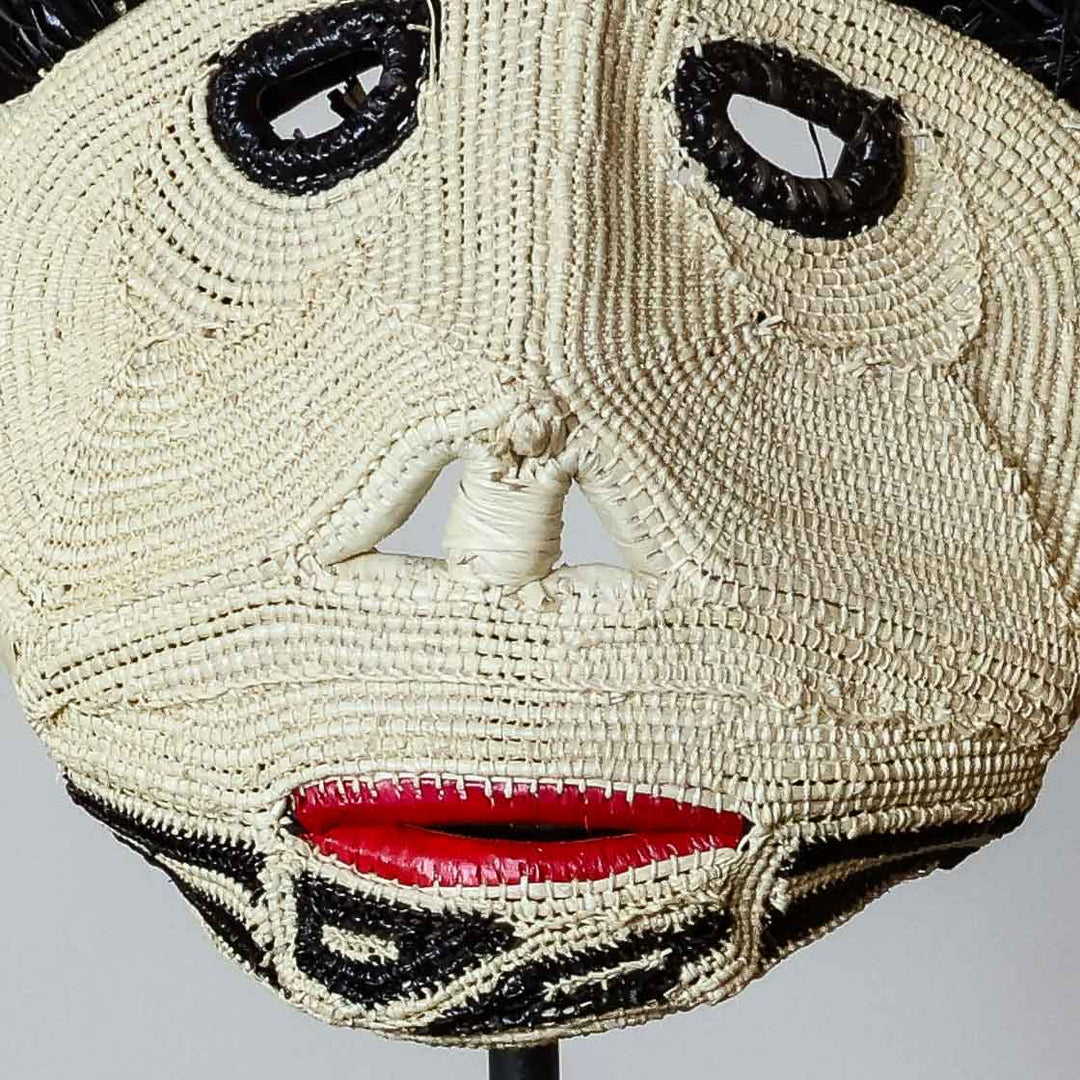 Detail of the woven face and red mouth on an Emberá spirit mask