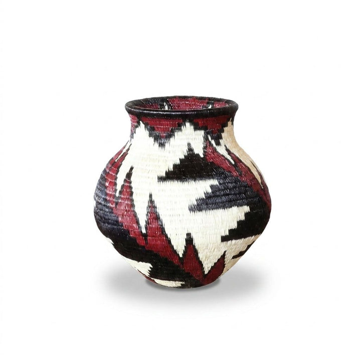 Side view of crimson feather handwoven Wounaan basket showing jagged red and black plumes on ivory