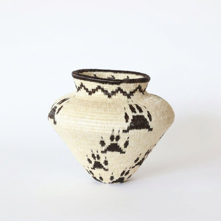 Jaguar paw print handwoven Wounaan basket in natural cream and dark brown with coiled dark rim, Panama
