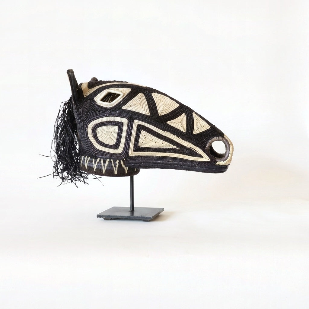 Dark geometry horse mask, bold black geometric lines on espresso palm fiber
