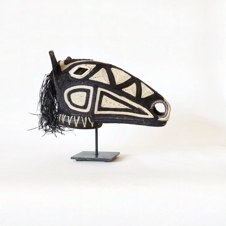 Dark geometry horse mask, bold black geometric lines on espresso palm fiber