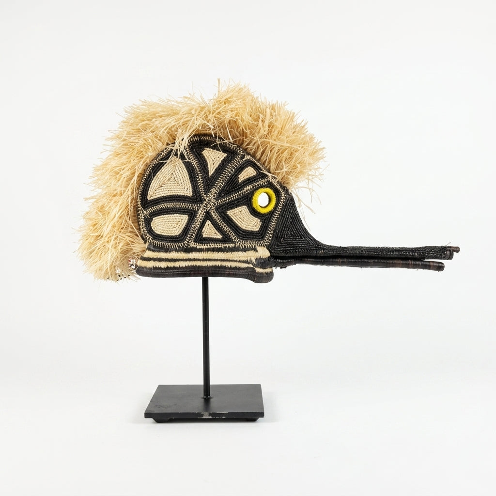 Handwoven Emberá hummingbird mask, ivory and black geometric head with golden eye and straw crest, from Panama