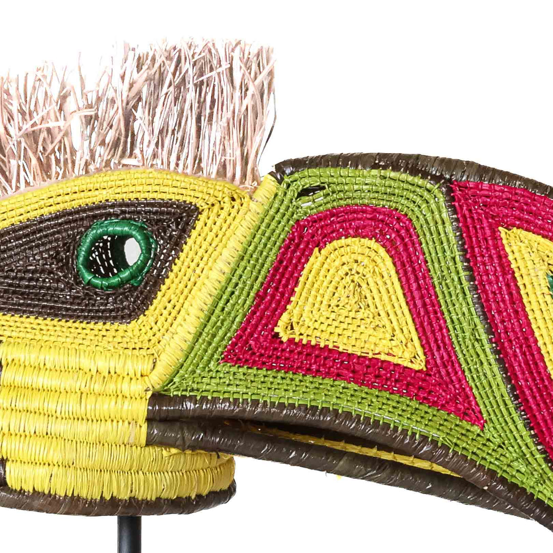 Close-up detail of crimson, yellow and green beadwork on handwoven Emberá toucan spirit mask