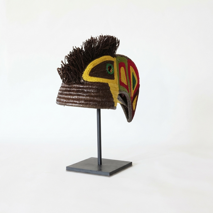 Emberá toucan woven mask alternate view, vivid geometric beak and yellow beaded face, wall art from Panama