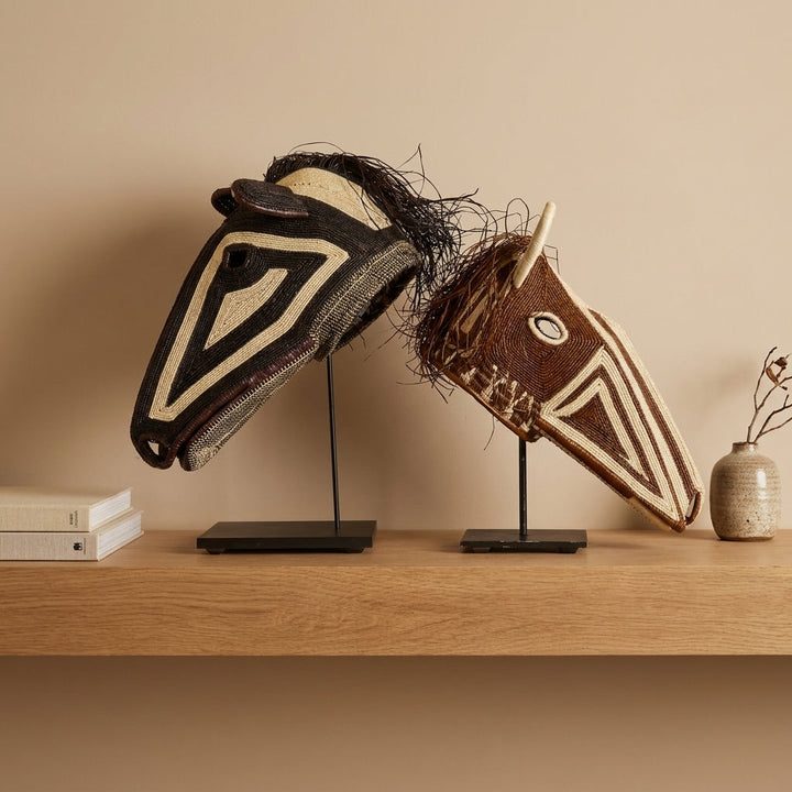 Two Emberá horse masks displayed together, dark and chestnut pair