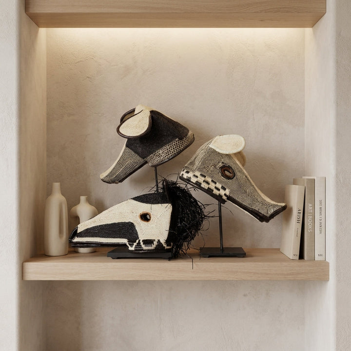 Three Emberá dog masks displayed together on shelf