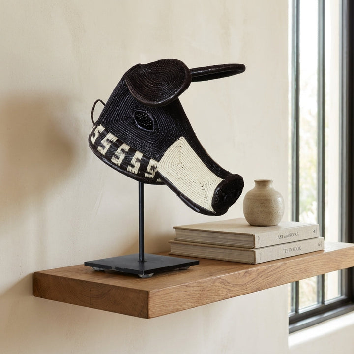 Black scroll dog mask on shelf, black and white S-scroll pattern Emberá art