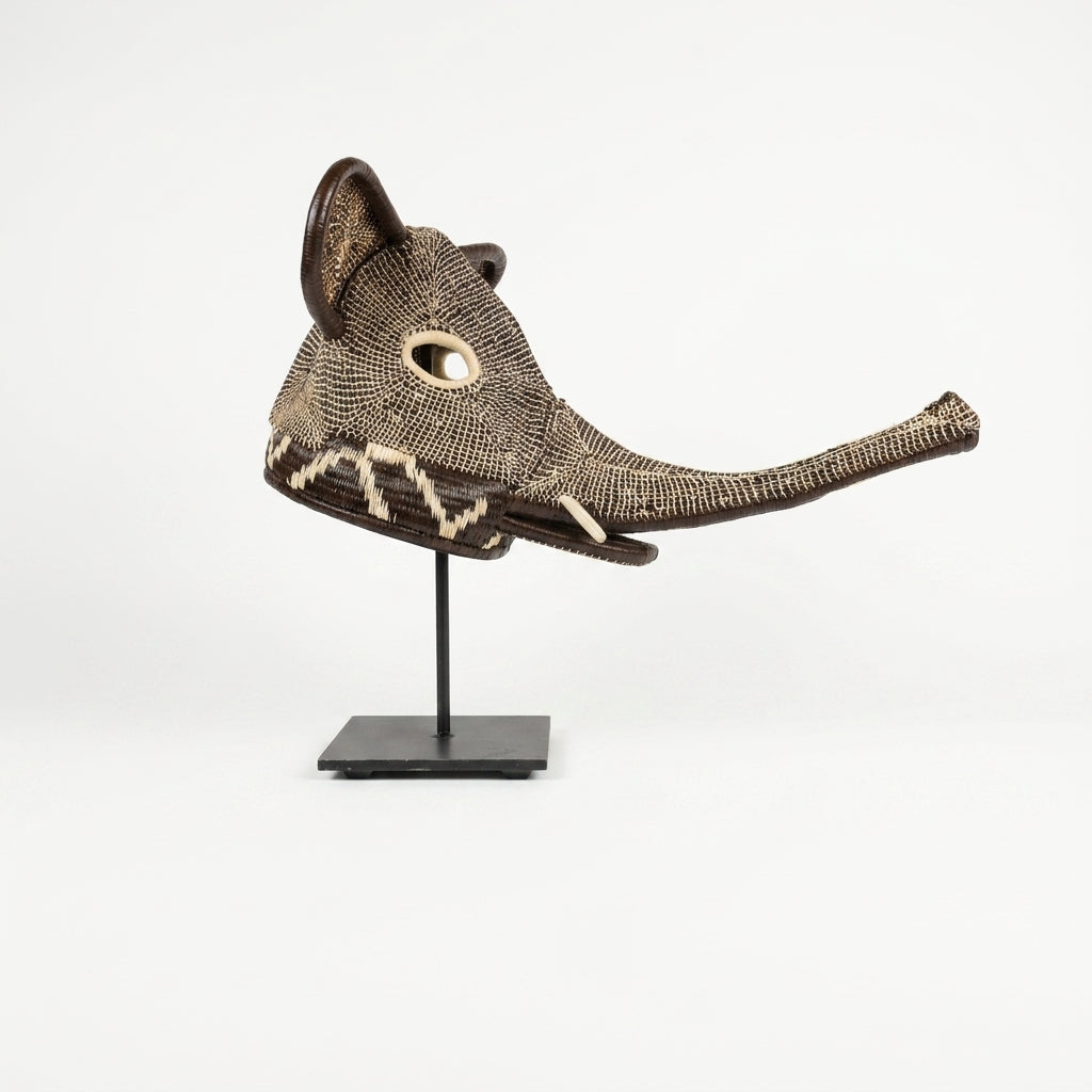 Handwoven Emberá elephant mask, tan and chestnut cross-hatch weave with woven trunk and tusks, from Panama