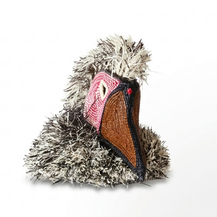 Emberá bird spirit mask angled view showing shaggy grey raffia and pink beaded face disc, palm fiber art