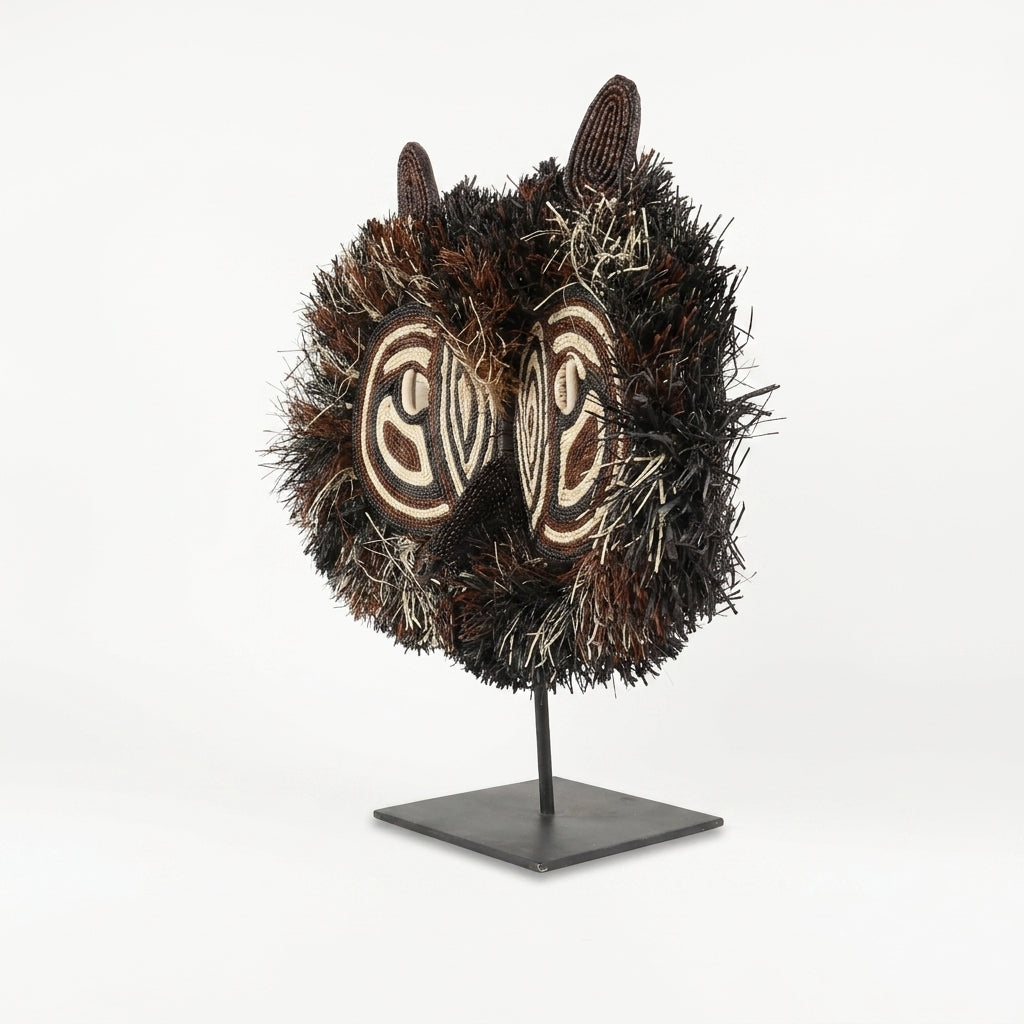 Emberá owl mask side view, shaggy palm-fiber ruff and ear tufts, Darién Panama