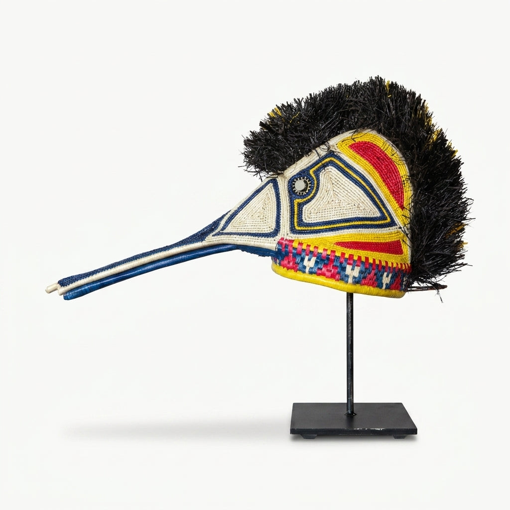 Handwoven Emberá hummingbird mask in white, blue, red and yellow with a long beak, from Panama