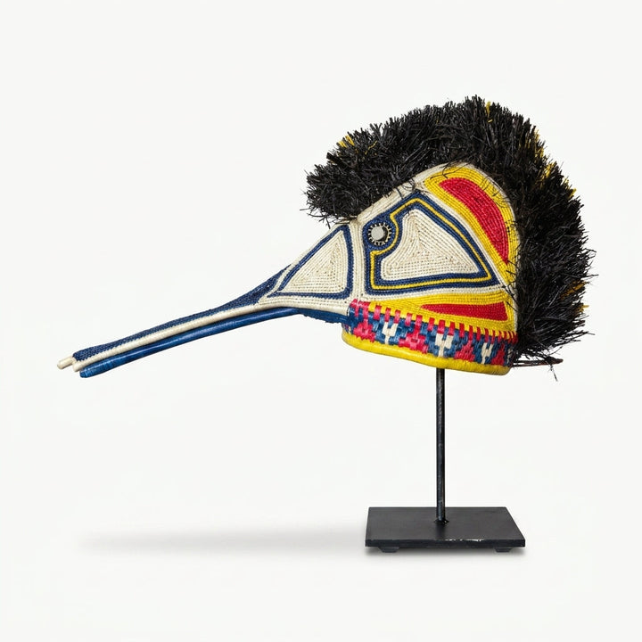 Handwoven Emberá hummingbird mask in white, blue, red and yellow with a long beak, from Panama