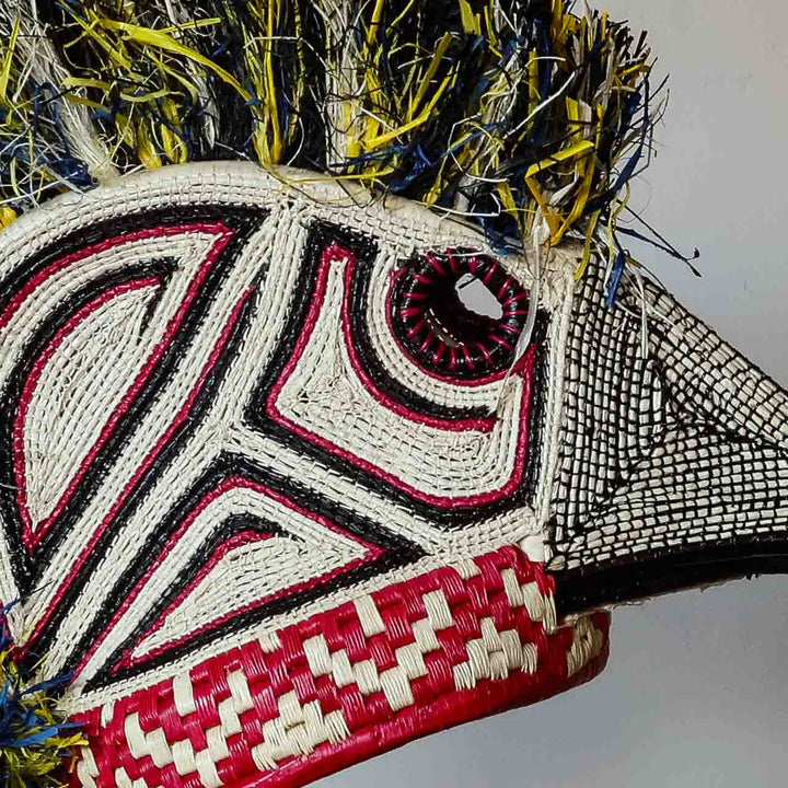 Detail of the crimson and black geometric weave on an Emberá hummingbird mask