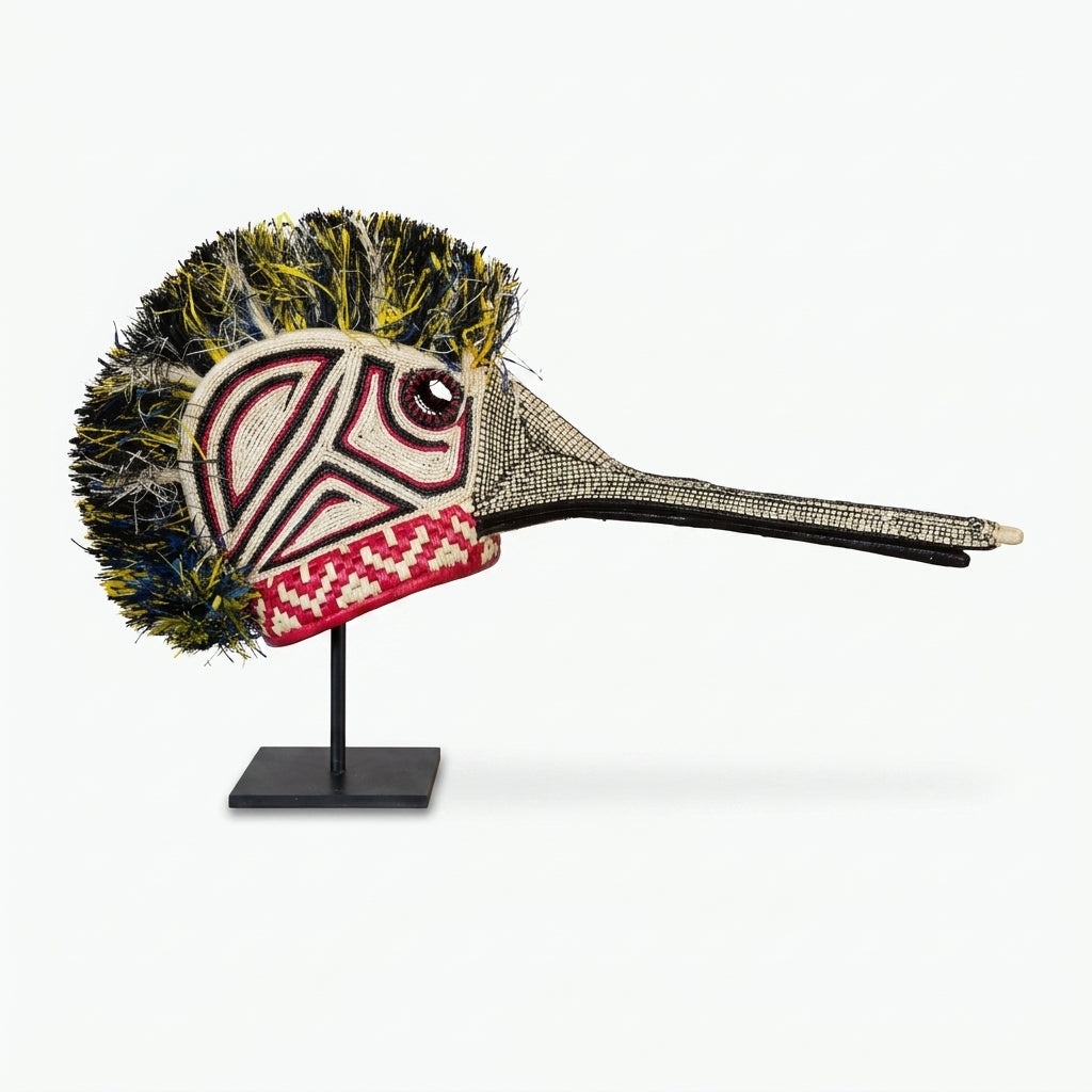 Handwoven Emberá hummingbird mask in ivory, crimson and black with a long beak, from Panama