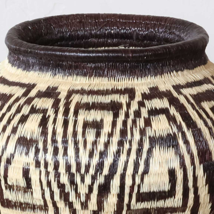 Close-up werregue palm fiber weave showing geometric labyrinth design craftsmanship detail