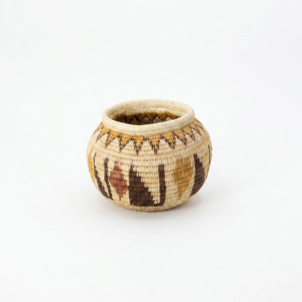 Small crimson woven basket handmade by indigenous artisans with traditional palm fiber weaving