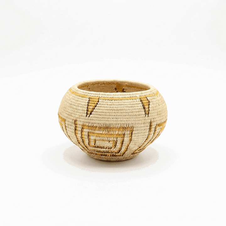 Small handwoven mini basket with golden geometric lines by weaver julia