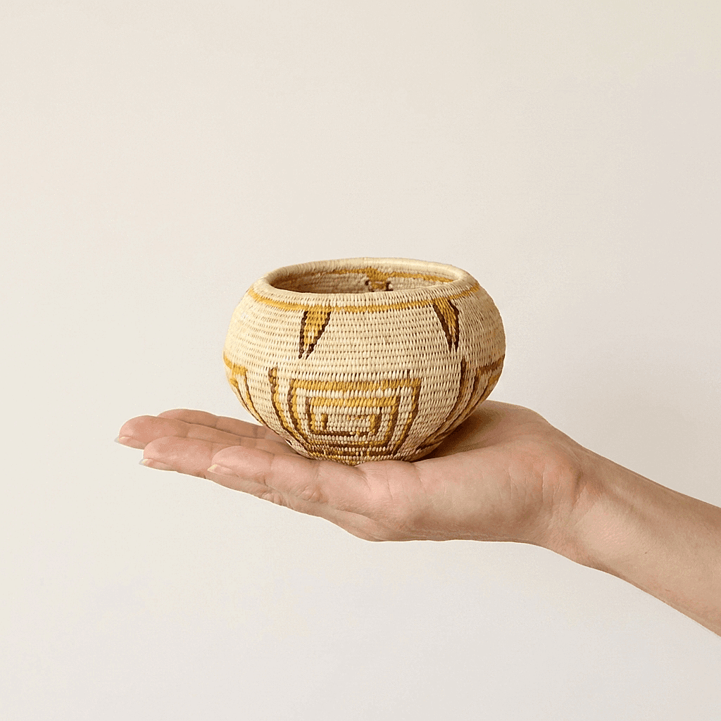 Small handwoven mini basket with golden geometric lines by indigenous artisans