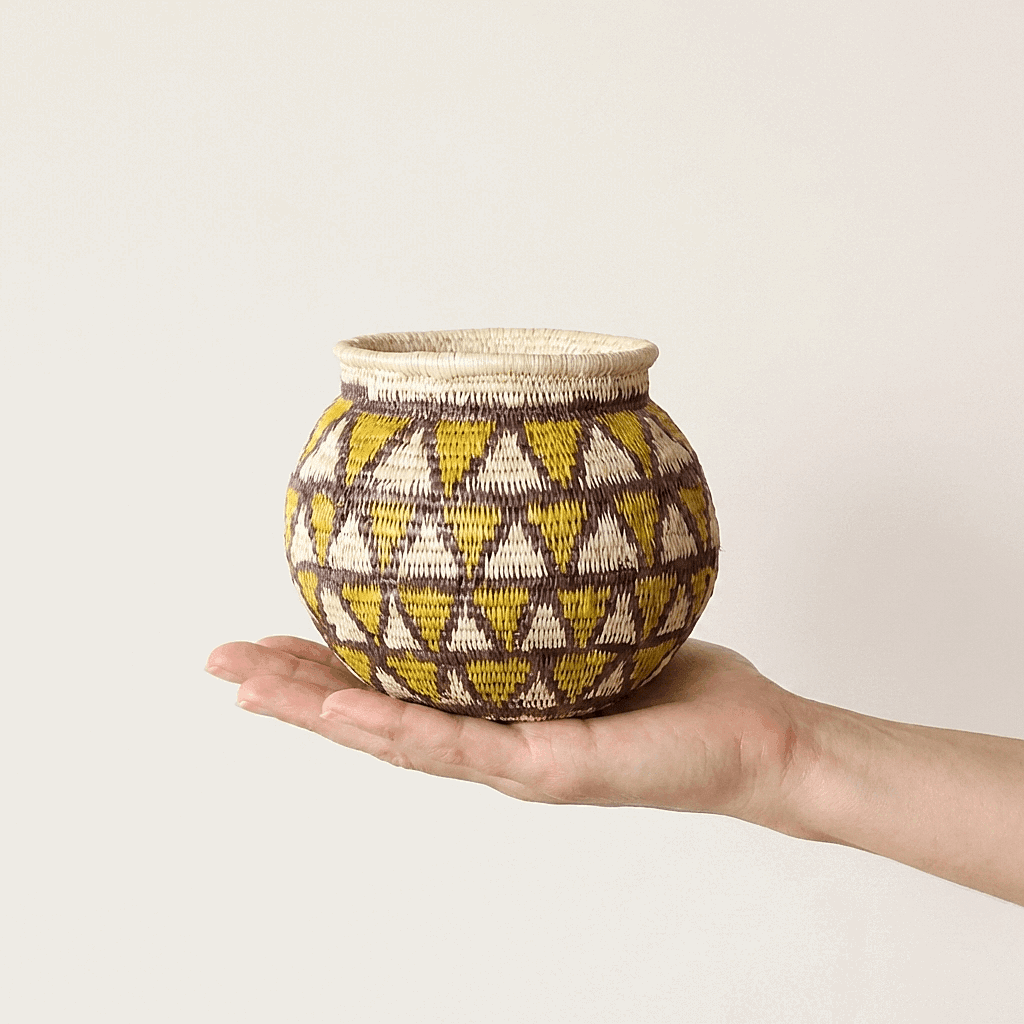 Small handmade basket golden diamond pattern black border indigenous woven palm fiber art