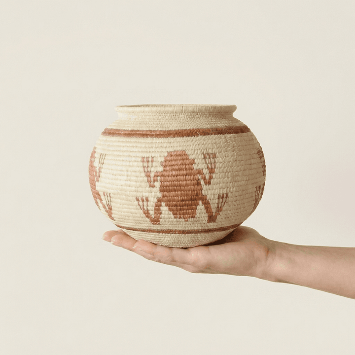 Small brown woven basket with frog motifs by Wounaan artisans from Panama Darién rainforest
