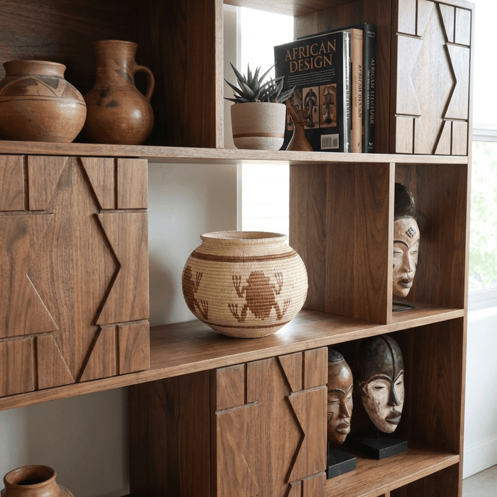 Handmade mini basket displayed on wooden shelf with other indigenous decorative baskets