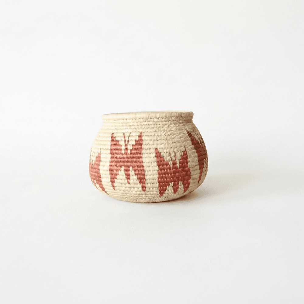Small vintage brown handmade basket with butterfly motifs woven by indigenous artisans