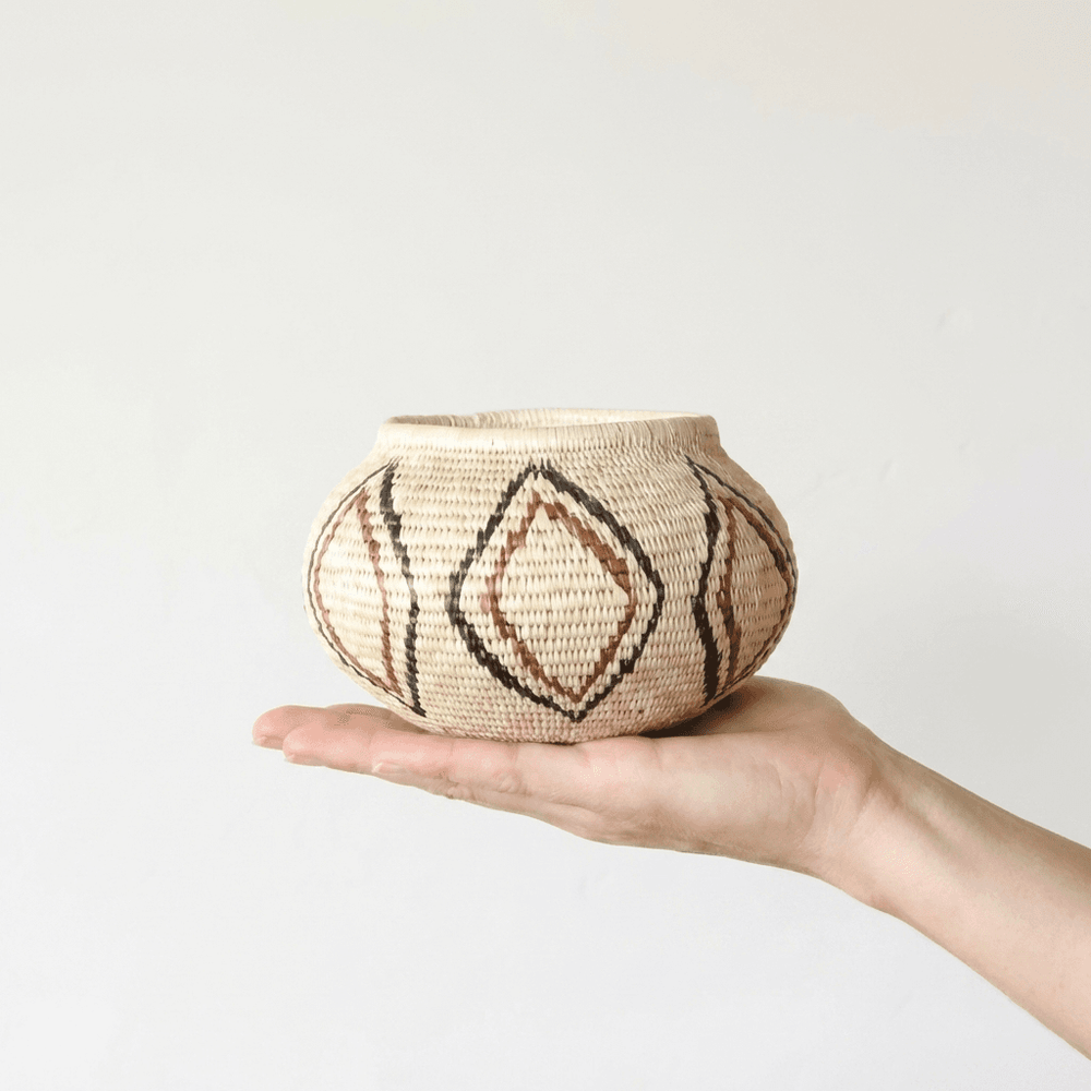 Small woven palm basket with vintage lined diamond patterns by indigenous artisans