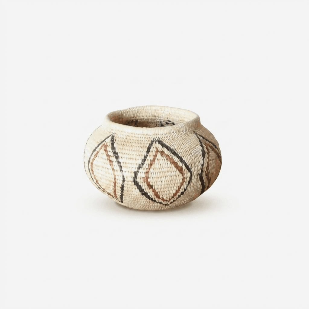 Small woven palm basket with vintage lined diamond patterns by indigenous artisans