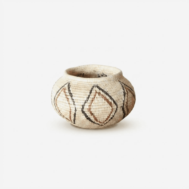 Small woven palm basket with vintage lined diamond patterns by indigenous artisans